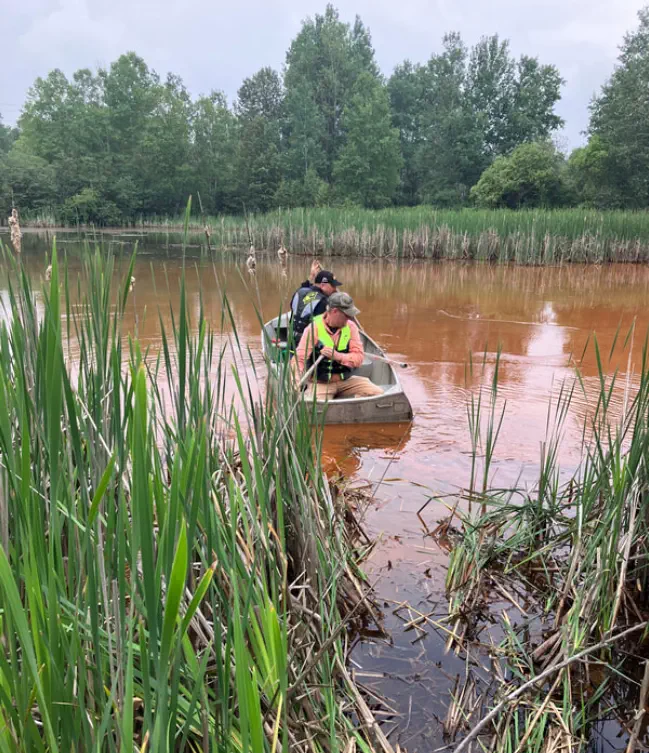 Men in canoe collecting data from the Dober Mine settling ponds Men in canoe collecting data from the Dober Mine settling ponds