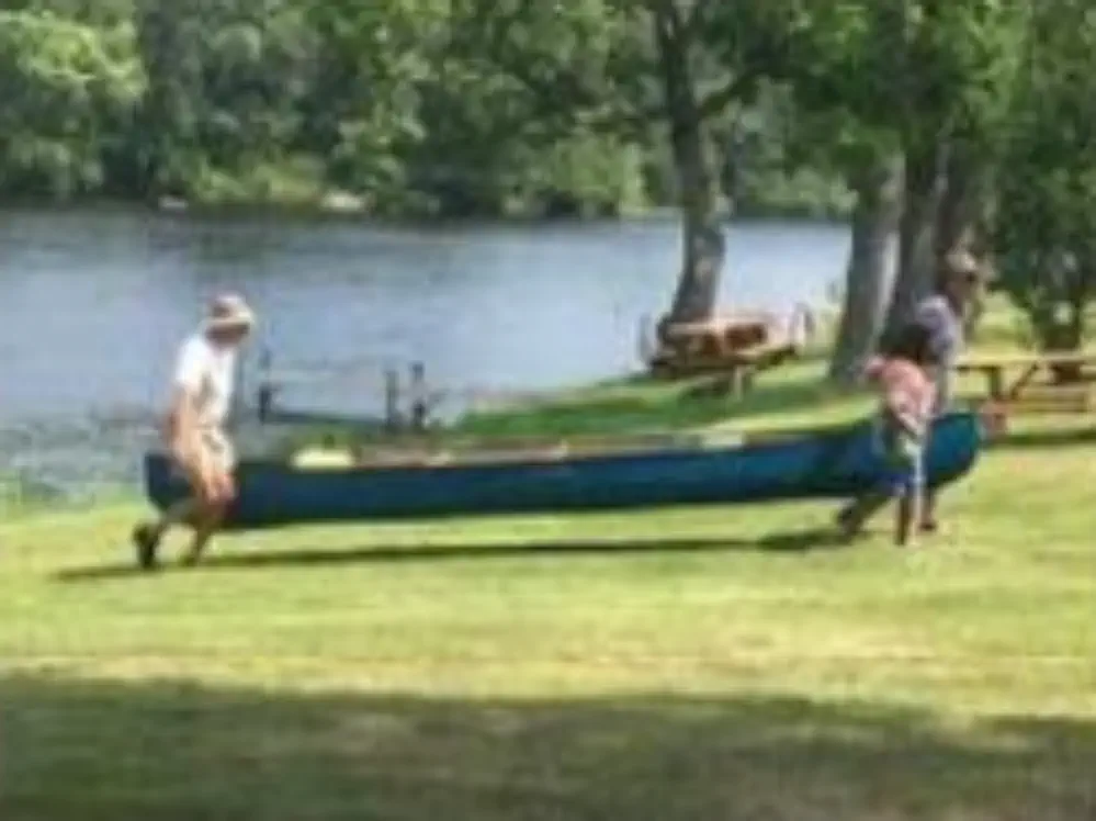 Carrying canoe during 2021 Paint River event