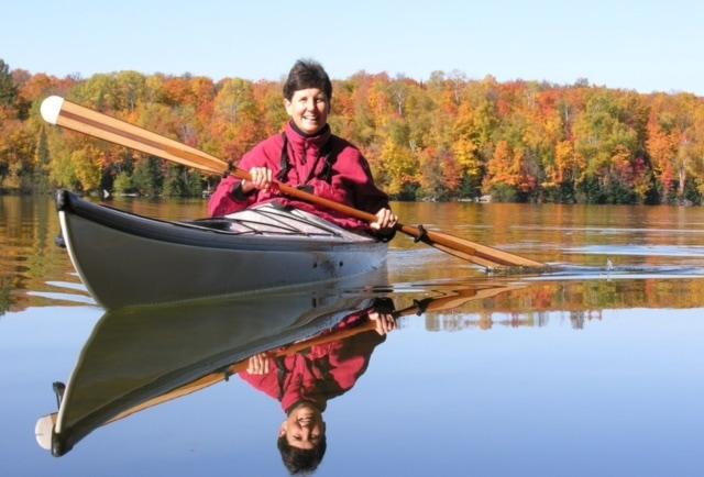 Bette Premo in a kayak on a lake in fall