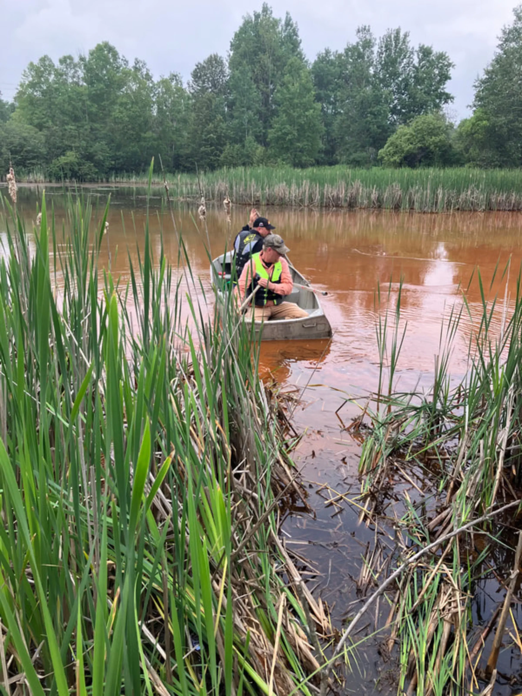 Menin kayak collecting data from the Dober Mine settling ponds.