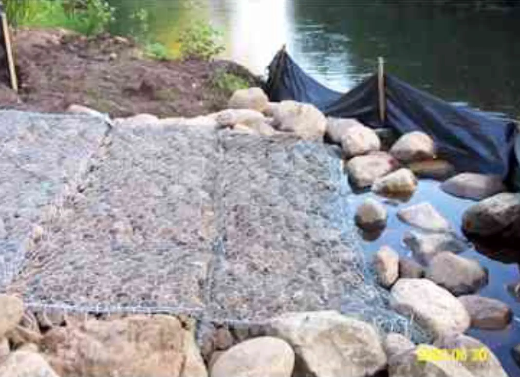 Netting installed to help stabilize hill