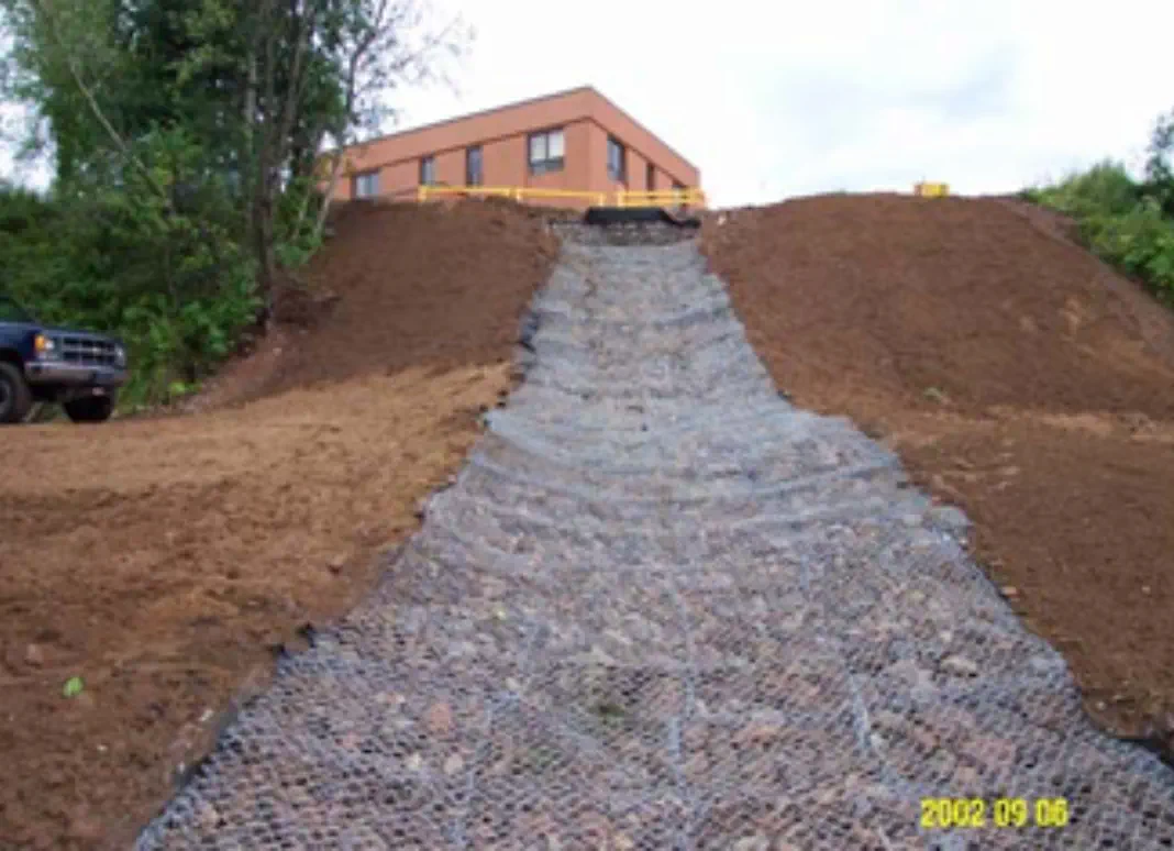 An 84 linear foot storm water conveyance channel was installed to reduce erosion