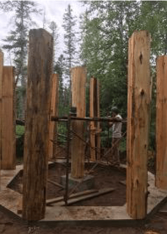 nine large cedar posts were brought in to the site on foot and erected at the corners