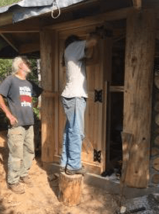 Rich Sloat and Mark Hovel install the door