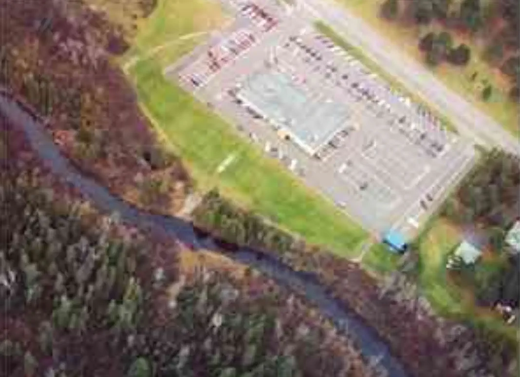 Drone view of parking lot next to river